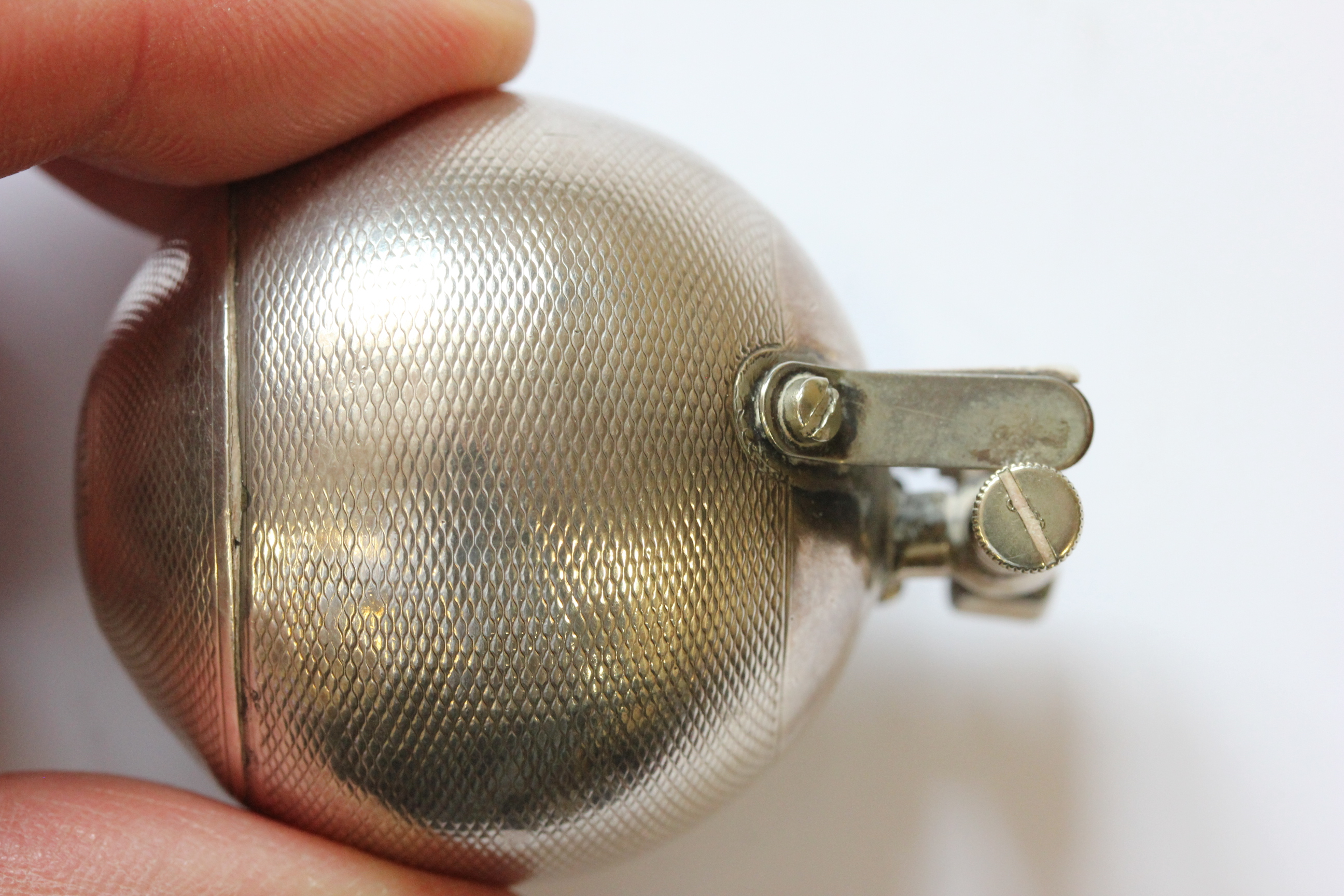 A hallmarked silver Dunhill lighter; of spherical form; with engine turned decoration; the hinged - Image 13 of 14