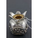 A 925 sterling standard silver candle holder; embossed with a village scene