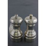 A hallmarked silver salt and pepper mill; of baulster shape; John Bull Ltd; London 1994