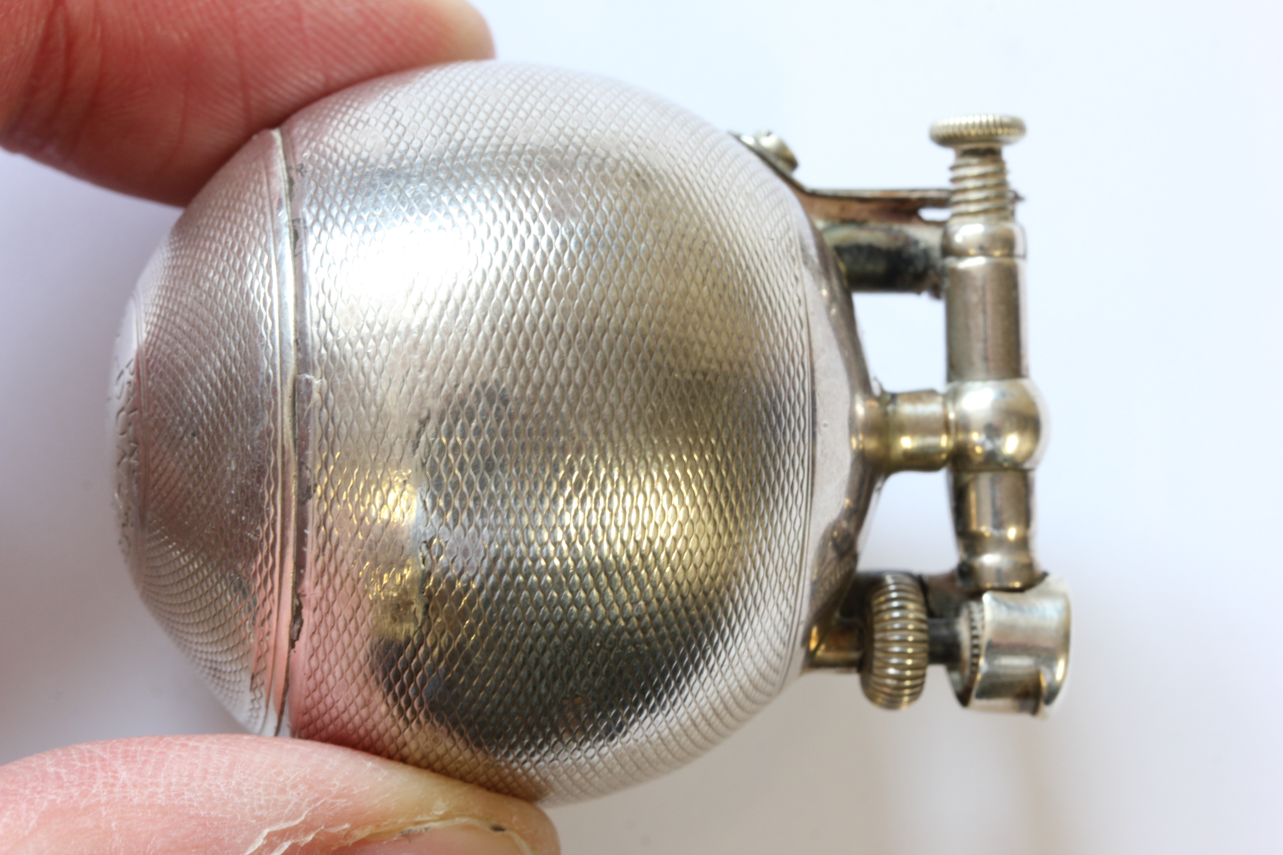 A hallmarked silver Dunhill lighter; of spherical form; with engine turned decoration; the hinged - Image 3 of 14