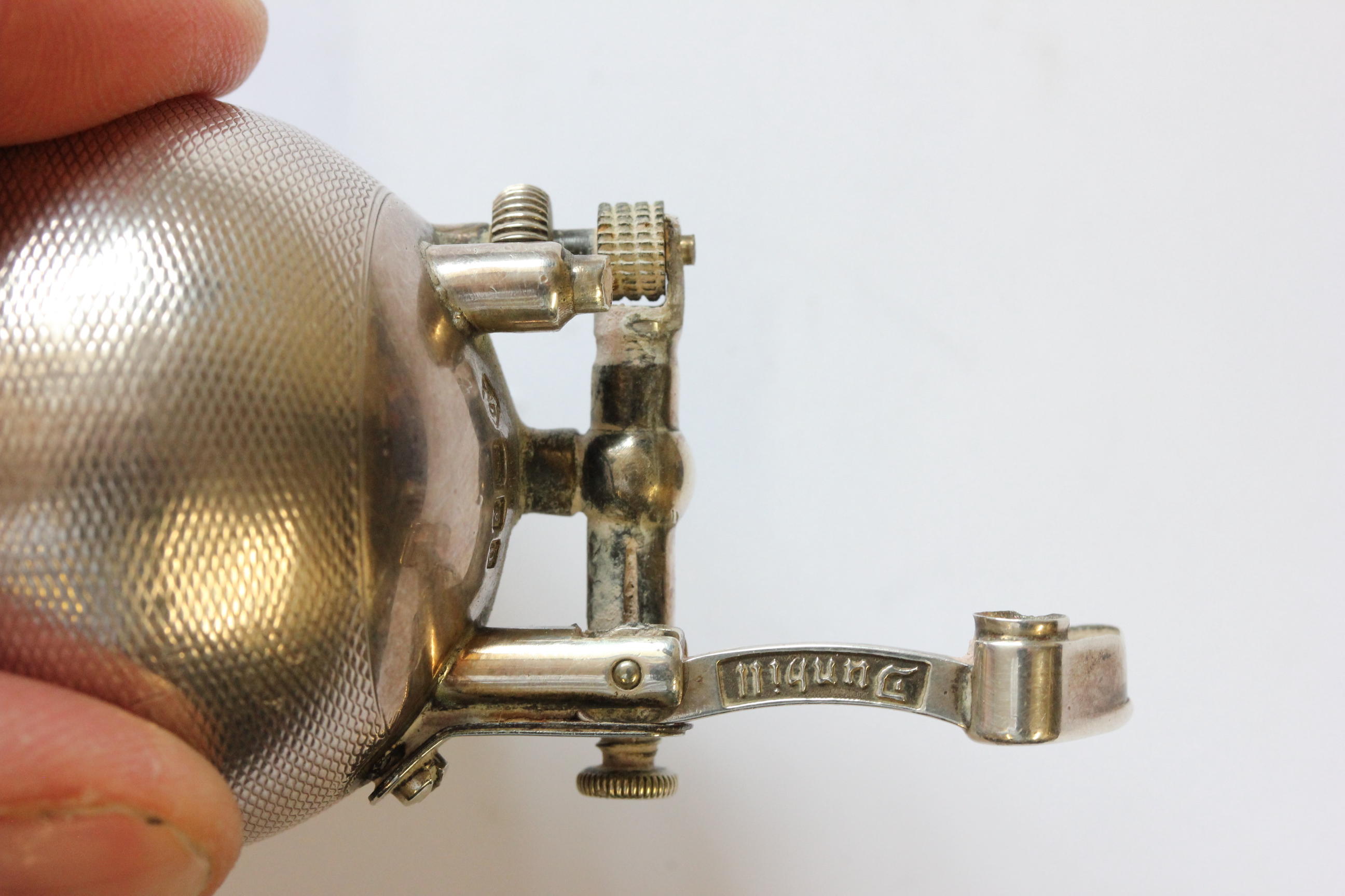 A hallmarked silver Dunhill lighter; of spherical form; with engine turned decoration; the hinged - Image 5 of 14