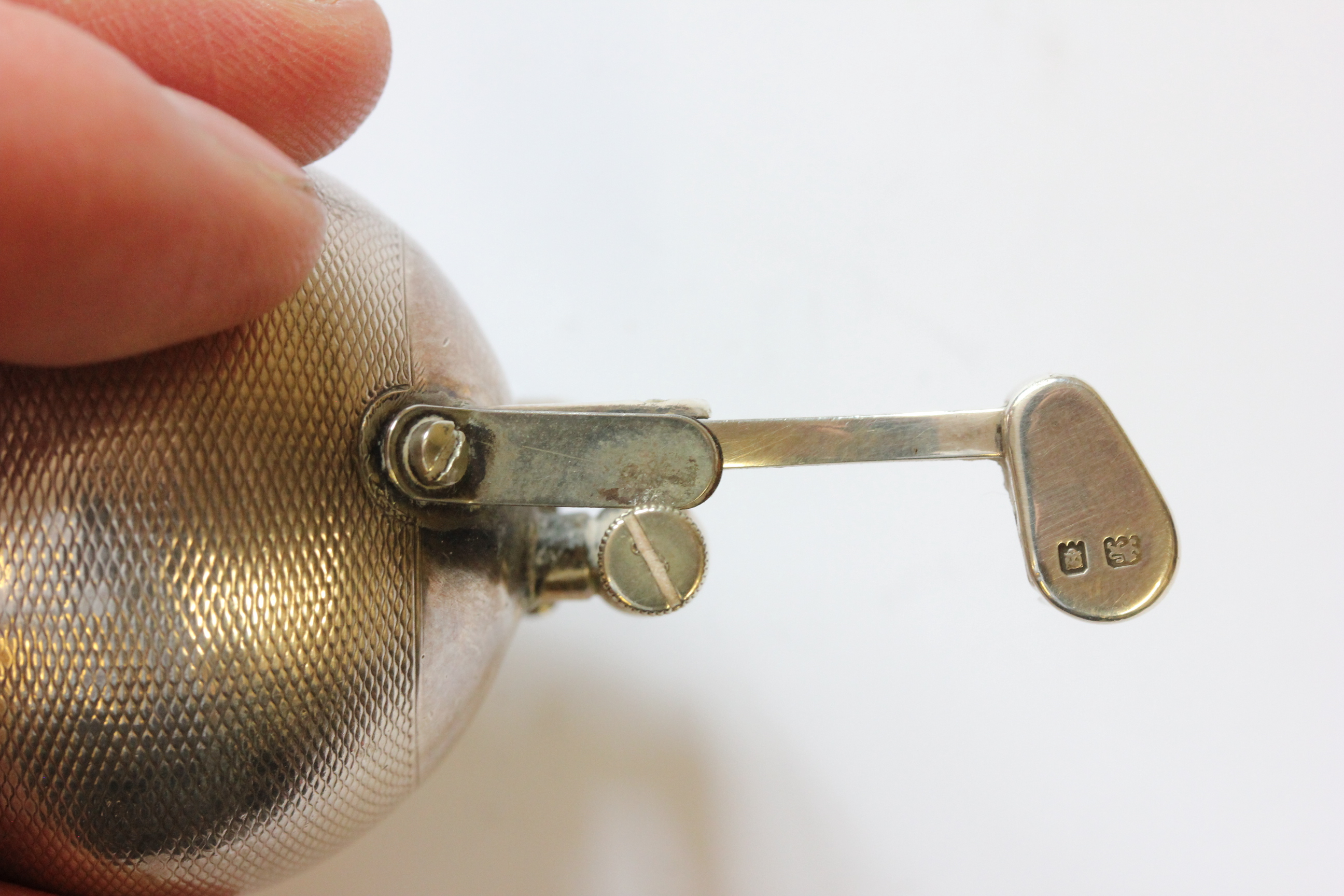 A hallmarked silver Dunhill lighter; of spherical form; with engine turned decoration; the hinged - Image 7 of 14