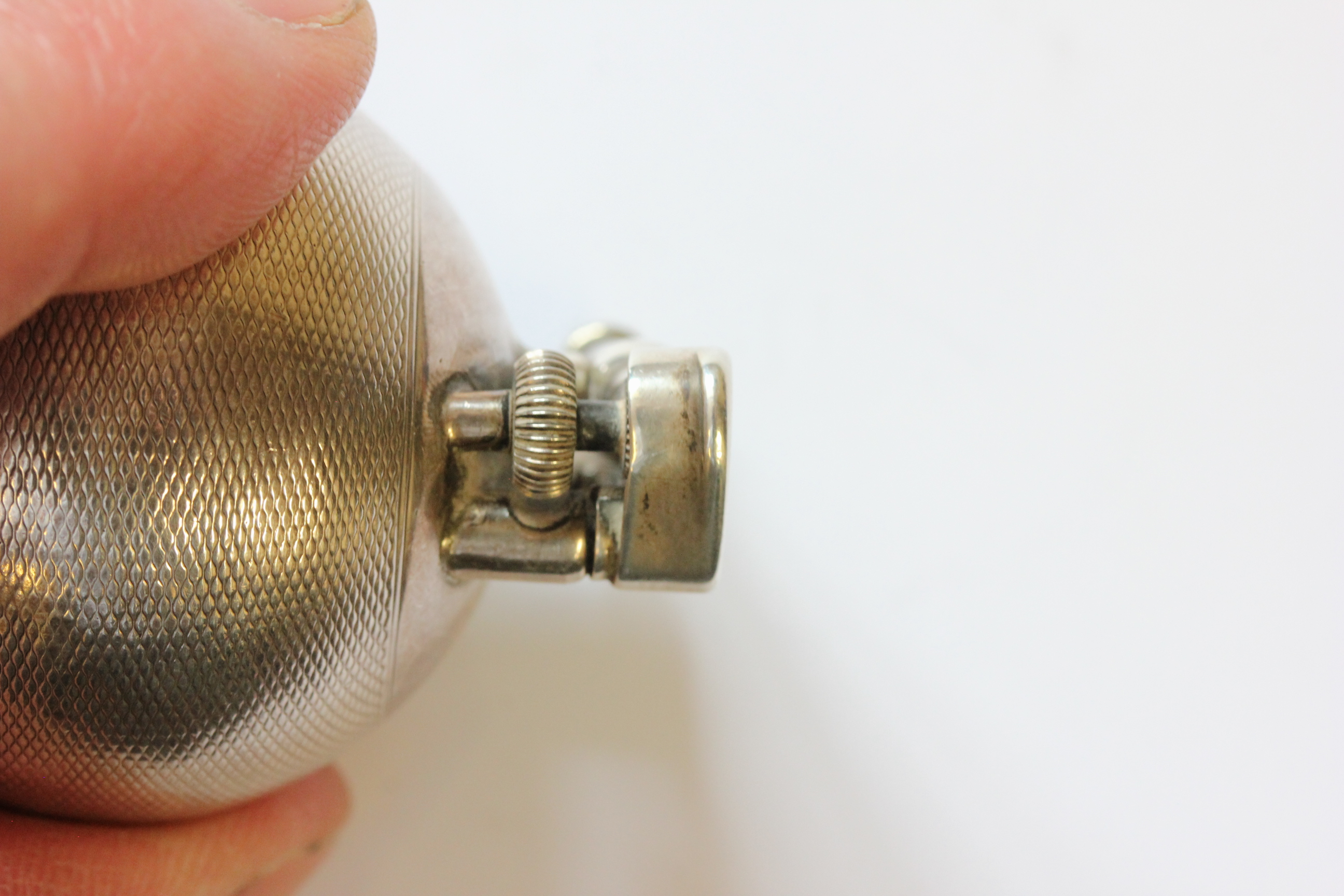 A hallmarked silver Dunhill lighter; of spherical form; with engine turned decoration; the hinged - Image 4 of 14