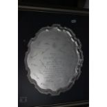 A hallmarked presentational silver salver; with pie crust rim; raised on three pad feet; Francis