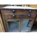 A Georgian mahogany twin door cabinet; with single fitted drawer; raised on four tapering supports