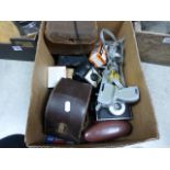 A box of various cameras to include; Kodak Brownie 127 and various camera accessories