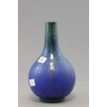 A studio pottery vase; of globular shape; painted in blue with a oil spot drip glaze; bearing script