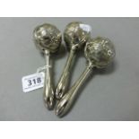 Three white metal babies rattles