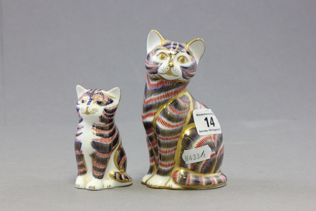 Two Royal Crown Derby paperweights each in the form of a seated cat; each with gold buttons