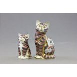 Two Royal Crown Derby paperweights each in the form of a seated cat; each with gold buttons