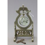 A vintage ball desk clock; on a white metal stand