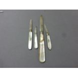 A group of four silver bladed folding fruit knives; each with mother of pearl handles