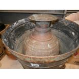 Galvanized copper coal bin raised on iron supports together with an Eastern copper vessel