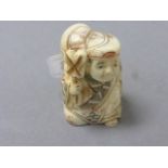 Oxbone netsuke of a man with sack