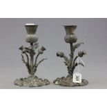 A pair of silver plated candlesticks; each in the form of a thistle on stems; bearing impressed