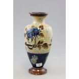 A Doulton Lambeth stoneware vase of baulster form; with applied floral decoration; bearing incised