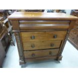 A mid 19th century walnut Scottish chest of four long drawers; raised on four ball feet