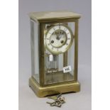 A late 19th century four glass brass mantle clock; with white enamel dial; black painted Roman