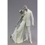 A Lladro porcelain figure of a man and woman dancing; with silver hair; bearing impressed marks to