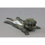 A painted spelter model of a flattened tiger