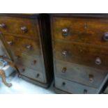 A pair of walnut chest of four short drawers; raised on pinth base