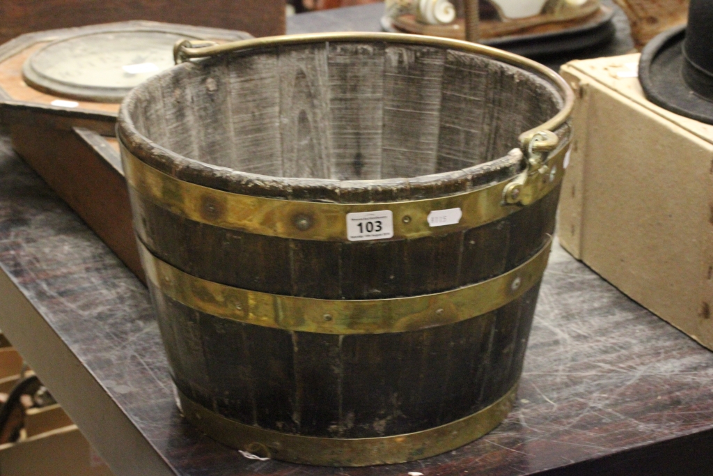 A vintage coal bucket made from a coopered barrel, with swing handle