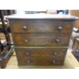 A Victorian walnut apprentices chest of four long drawers; with knop handles