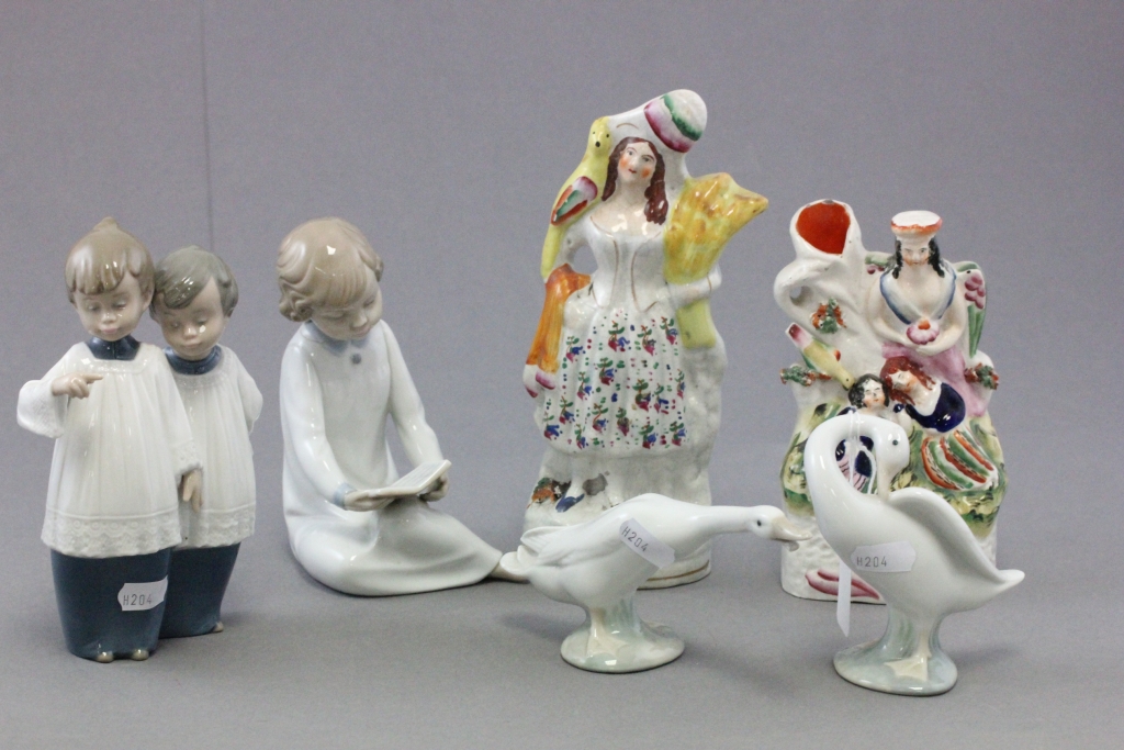 Two Nao porcelain figures; Two choir boys and a girl reading; together with Lladro porcelain geese