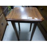 A 1930s occasional table raised on hexagonal tapering supports