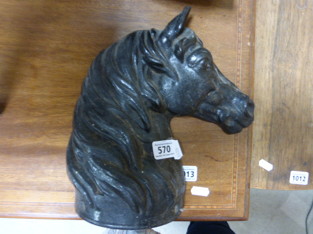 A cast iron door stop in the form of a horses head