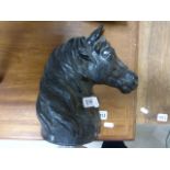 A cast iron door stop in the form of a horses head