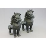 A pair of cast iron Chinese mythical creatures