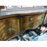A Regency style mahogany serpentine fronted sideboard; raised on square supports terminating in