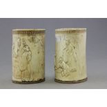 A pair of Chinese ivory tusk vases; one carved with three Chinese men by a cooking pot; the other