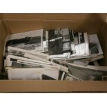 A box of various black and white photographs; mainly relating to trains and locomotives