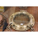 A vintage brass and glass porthole