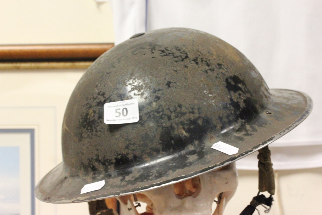 A World War II military tin helmet