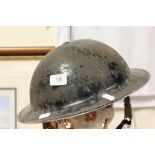 A World War II military tin helmet