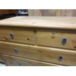 A pine chest of two short over two long drawers; raised on supports