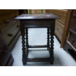 An antique oak joint stool