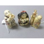 Three netsuke type carvings to include Boy Buddha playing horn, old man traveller and lady with