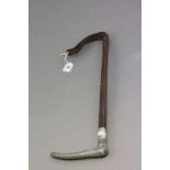 An antler style metal headed riding crop