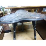 A 1930s oak carved tripod table