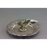 A possibly Indian silver ashtray; with pierced floral decoration; the central ash holder in the form