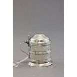 A small hallmarked silver lidded mustard; in the form of lidded vessel; with 'C' scroll handle;