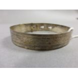 A hallmarked silver bangle; in the form of a belt