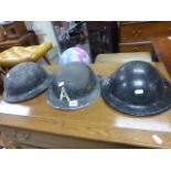 Three World War II tin helmets