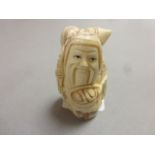 Signed oxbone netsuke of an old man traveller