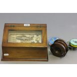 A boxed cased fishing diorama; together with vintage fishing reels and tackle