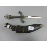 A Scottish highland kukri; together with a replica white metal German (Nazi) dagger; surmounted with